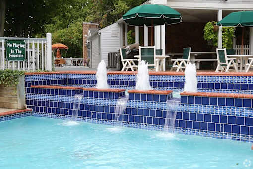 A pool with a sign that says "No Playing In The Fountain".