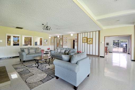 A living room with a grey couch and a coffee table.