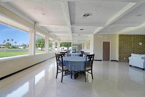A dining room with a table set for four.