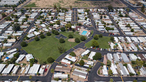 A bird's eye view of a neighborhood with houses and a green space.