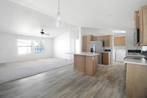 A kitchen with wooden cabinets and a white ceiling.