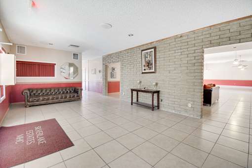 A room with a brick wall and a bench.