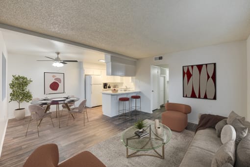 an open living room and kitchen with a table and chairs
