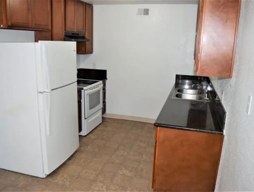 a kitchen with a refrigerator and a stove and a sink