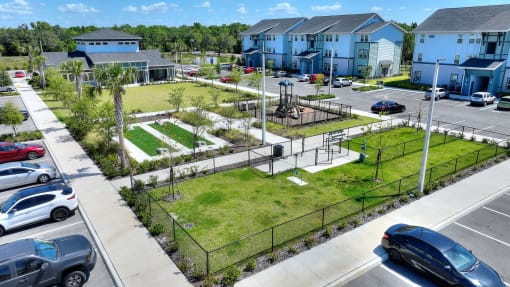 an aerial view of a park in the middle of a parking lot