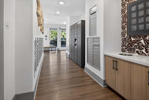 A long hallway with wood floors and white walls.