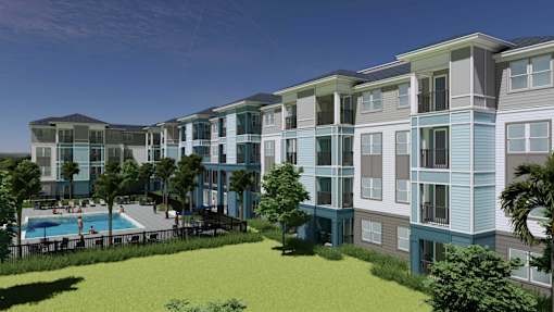A modern apartment complex with a pool and green lawn.