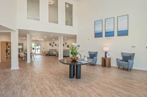 A spacious living room with a round table and chairs.