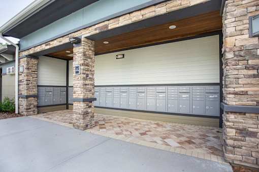 A garage door is closed and there are 11 lockers on the wall.