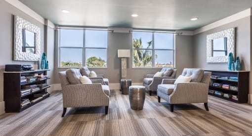 a waiting room with couches chairs and a bookshelf