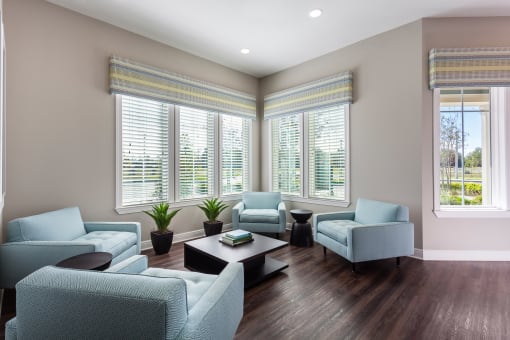 a living room filled with furniture and a large window