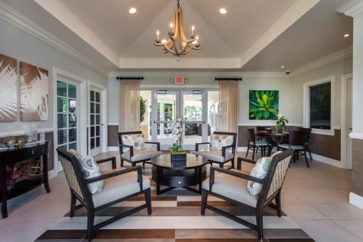 a living room filled with furniture and a chandelier