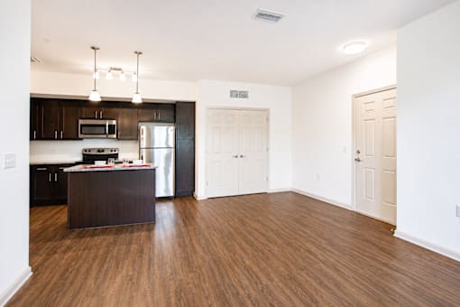A kitchen with dark wood cabinets and a white refrigerator.