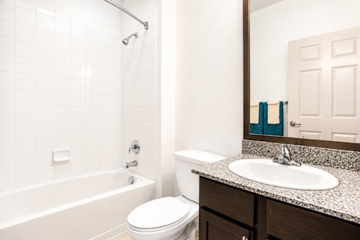 A white toilet sits next to a sink in a bathroom.