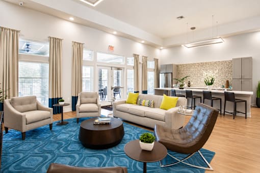 A living room with a blue carpet and furniture.