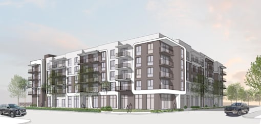 A modern apartment building with balconies and multiple stories.