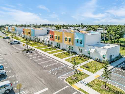 a row of colorful houses in a parking lot