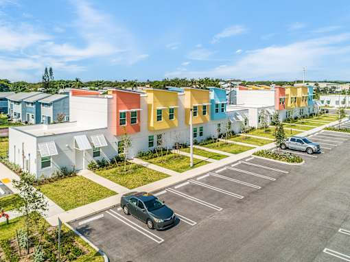 a row of colorful houses in a parking lot
