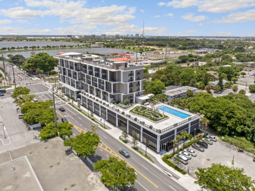 an aerial view of a large building with a pool in front of it