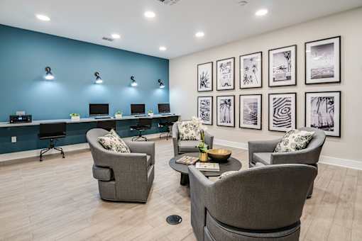 A room with blue walls and a row of framed pictures on the wall.