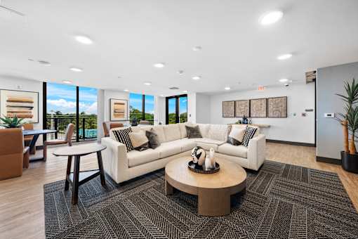 A modern living room with a white sofa and a coffee table.
