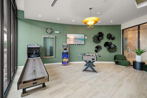 A room with a bowling alley table and a pool table.