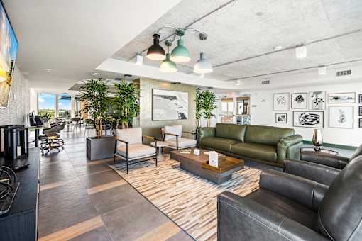 A modern living room with a green couch and a wooden floor.