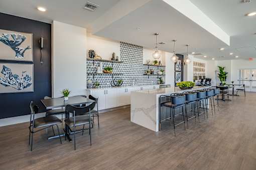 A modern dining area with a long table and chairs.