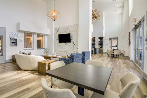 A modern living room with a large table and chairs.