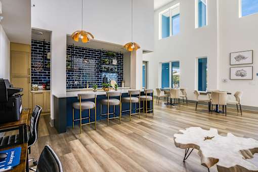 A modern kitchen with a bar area and a dining table.