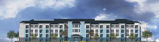 A large hotel with a black roof and blue trim.