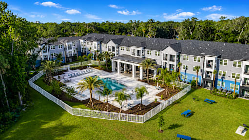 A large building complex with a pool in the middle.