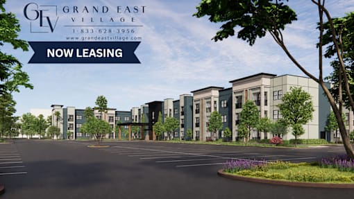 A rendering of a modern apartment complex with the text "Grand East Village" and "Now Leasing" prominently displayed.