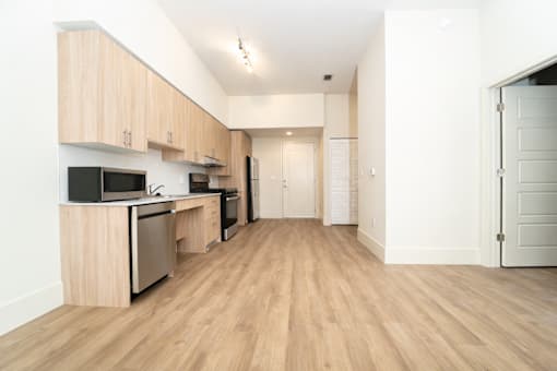 A kitchen with wooden floors and white walls.