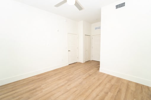 A room with wooden floors and white walls.