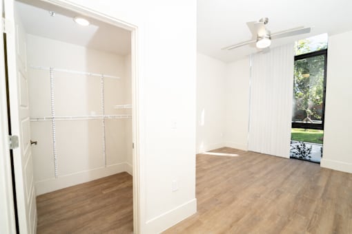 Empty room with white walls and wooden floor.