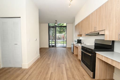 A kitchen with wooden floors and white walls.