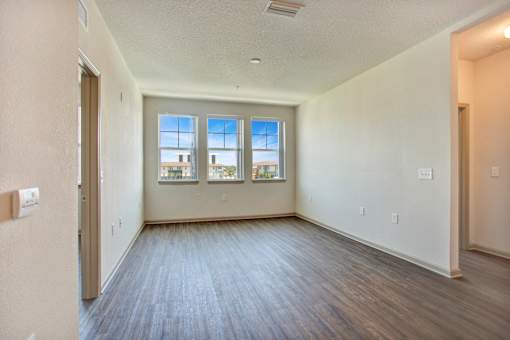 A room with a window overlooking a building.