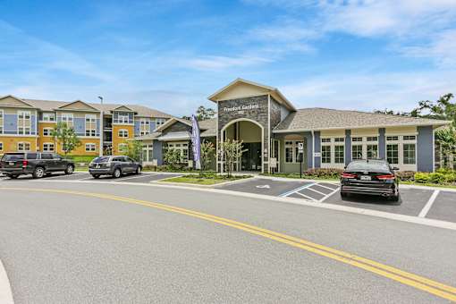 A building with a sign that says "Garden Grove Community College" in front of it.