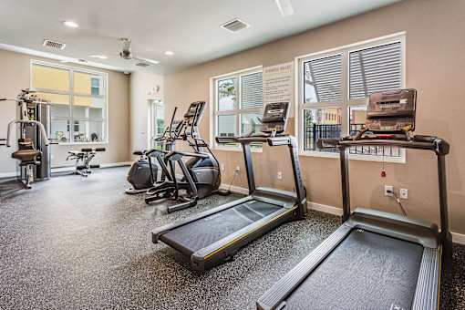 the gym with treadmills and exercise equipment at 1861 muleshoe road apartments