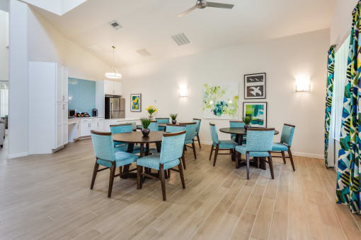 gather around the dining table in the clubhouse at enclave at woodbridge apartments in sugar land,