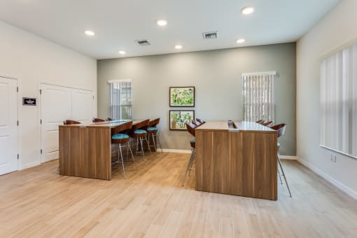 a meeting room with two tables and chairs