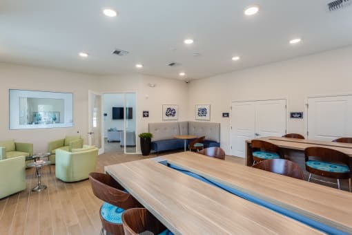 a common room with a ping pong table and couches