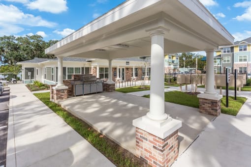a covered patio with a grill and barbecue