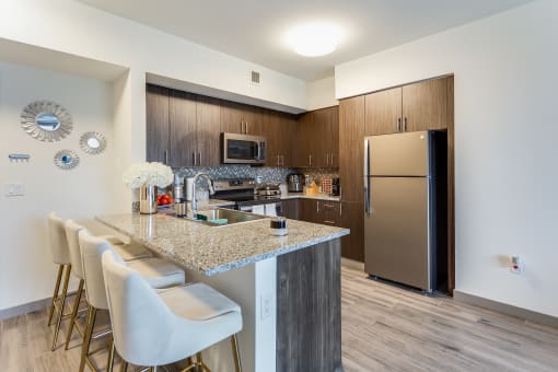 a kitchen with granite countertops and stainless steel appliances
