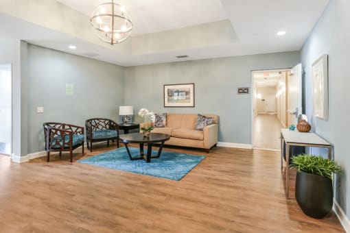 a living room with a couch table and chairs