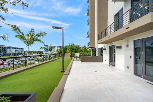 A modern building with a green lawn in front.