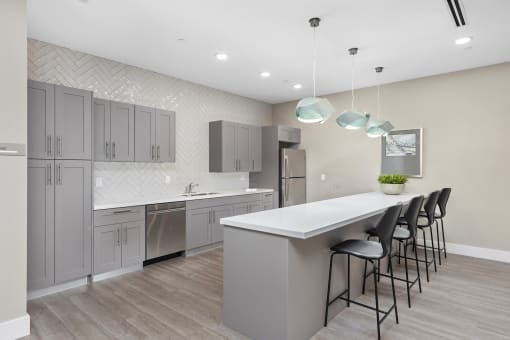 a kitchen with gray cabinets and a white counter top