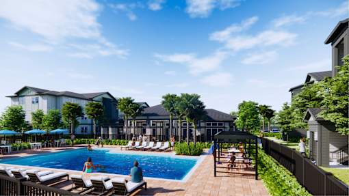 A pool area with people relaxing and a building in the background.