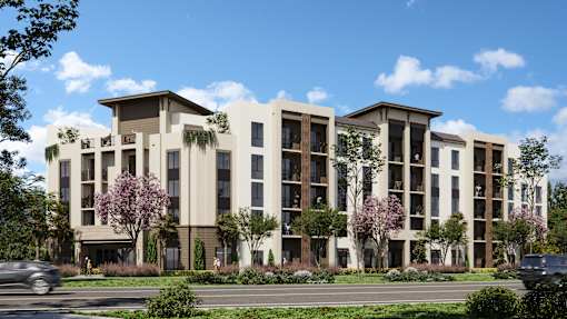 A modern apartment building with a clear blue sky above.